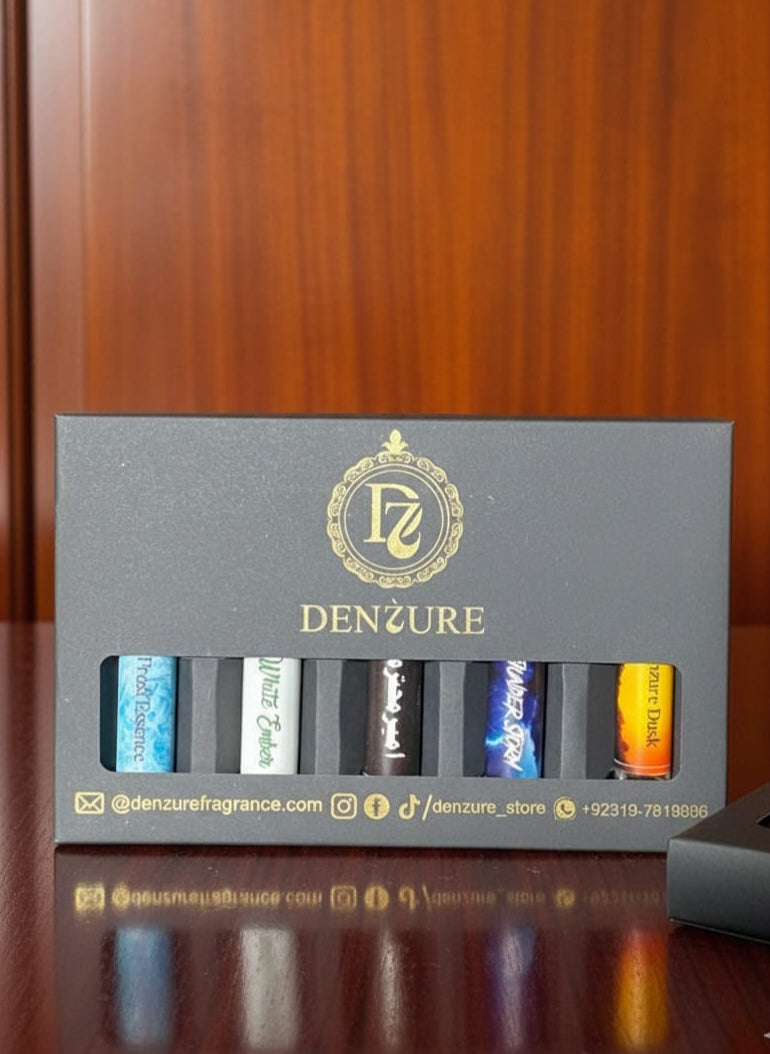 Denzure fragrance set with five bottles in a row on a wooden surface