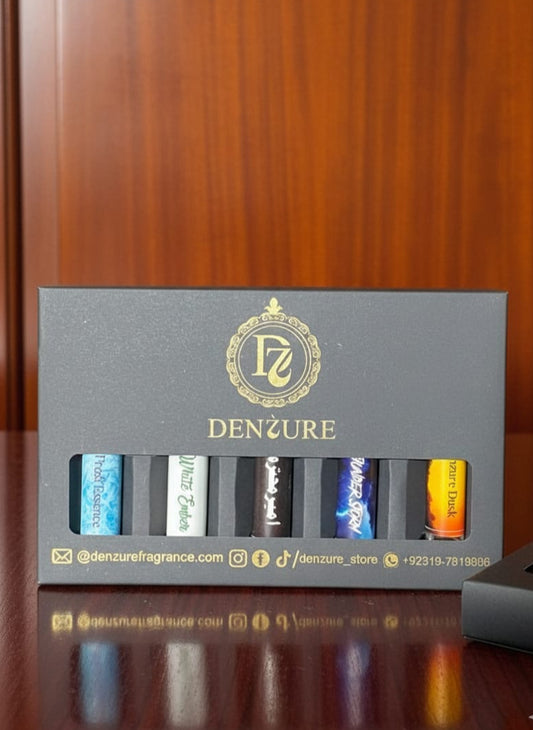 Denzure fragrance set with five bottles in a row on a wooden surface